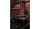Close-up on an elegant black, silver, and red bathroom sink with designer fixtures at 64 Promontory Ridge Dr, Las Vegas, NV 89135