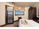 Serene bedroom features mountain views, balcony access, and elegant furnishings at 64 Promontory Ridge Dr, Las Vegas, NV 89135