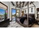 Bright bedroom featuring a four-poster bed and an open glass door to the backyard pool area at 64 Promontory Ridge Dr, Las Vegas, NV 89135