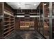 Spacious walk-in closet with custom shelving, glass cabinets, and ample storage for an organized wardrobe at 64 Promontory Ridge Dr, Las Vegas, NV 89135