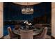 Dining room displays a round table, chic lighting, and stunning city views at 64 Promontory Ridge Dr, Las Vegas, NV 89135
