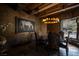 Formal dining room featuring a designer chandelier, a horse painting, and exterior views at 64 Promontory Ridge Dr, Las Vegas, NV 89135