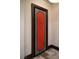 Unique interior door with a striking red panel, adding a pop of color and character to the hallway at 64 Promontory Ridge Dr, Las Vegas, NV 89135
