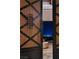 Close up of an iron and wood entry door with a view of the city skyline at 64 Promontory Ridge Dr, Las Vegas, NV 89135