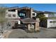 Exterior of luxury home featuring covered porte-cochere entrance and desert landscaping at 64 Promontory Ridge Dr, Las Vegas, NV 89135