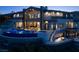 Beautiful two-story home features a sparkling pool, hot tub, and hillside views at 64 Promontory Ridge Dr, Las Vegas, NV 89135