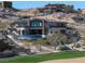 Stunning hillside estate boasts an outdoor pool and spa, set against picturesque desert landscape at 64 Promontory Ridge Dr, Las Vegas, NV 89135