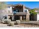 Gorgeous home with a stone facade, manicured landscaping and covered entryway at 64 Promontory Ridge Dr, Las Vegas, NV 89135
