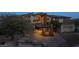 Luxury home with covered porte-cochere entrance and desert landscaping in a secluded location at 64 Promontory Ridge Dr, Las Vegas, NV 89135