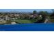 A beautiful view of a golf course and driving range overlooking the Las Vegas skyline at 64 Promontory Ridge Dr, Las Vegas, NV 89135