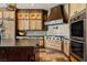 Bright kitchen with stone tile flooring, designer cabinets, and stainless-steel appliances at 64 Promontory Ridge Dr, Las Vegas, NV 89135