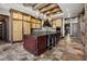 Open kitchen with a central island, stone tile floors, and stainless-steel appliances at 64 Promontory Ridge Dr, Las Vegas, NV 89135