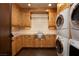 Well-equipped laundry room boasts custom cabinets and modern appliances at 64 Promontory Ridge Dr, Las Vegas, NV 89135