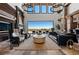 Elegant living room with high ceilings, chandelier lighting, comfortable furniture and an expansive view of the outdoors at 64 Promontory Ridge Dr, Las Vegas, NV 89135