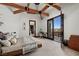 The spacious bedroom has beamed ceilings, and balcony access at 64 Promontory Ridge Dr, Las Vegas, NV 89135