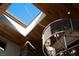 A stylish ceiling and modern chandelier beneath a skylight brighten the space at 64 Promontory Ridge Dr, Las Vegas, NV 89135