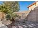 Landscaped backyard featuring desert plants and rocks, surrounded by privacy wall at 7232 Frontier Hills Ave, Las Vegas, NV 89113