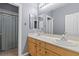 Well-lit bathroom featuring double sinks and a shower, designed for convenience and comfort at 7232 Frontier Hills Ave, Las Vegas, NV 89113