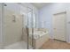 Modern bathroom with soaking tub and glass enclosed shower at 7232 Frontier Hills Ave, Las Vegas, NV 89113