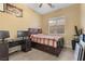 Bright bedroom with a ceiling fan and generous window, offering a refreshing and airy feel at 7232 Frontier Hills Ave, Las Vegas, NV 89113