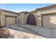 Home exterior featuring two-car garage and private gate at 7232 Frontier Hills Ave, Las Vegas, NV 89113