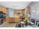 Open kitchen with a large center island, stainless appliances, and adjacent dining area at 7232 Frontier Hills Ave, Las Vegas, NV 89113