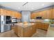 Open kitchen with a large center island, stainless appliances, and neutral countertops at 7232 Frontier Hills Ave, Las Vegas, NV 89113
