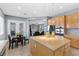 Kitchen featuring an island and stainless steel appliances with a view into the Gathering room at 7232 Frontier Hills Ave, Las Vegas, NV 89113