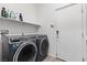 Functional laundry room equipped with modern appliances and a convenient storage shelf for supplies at 7232 Frontier Hills Ave, Las Vegas, NV 89113