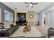 Inviting living room featuring a cozy fireplace, a ceiling fan, and comfortable leather seating at 7232 Frontier Hills Ave, Las Vegas, NV 89113