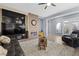 Spacious living room with a fireplace, large windows, and comfortable seating arrangement at 7232 Frontier Hills Ave, Las Vegas, NV 89113