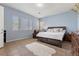 Spacious main bedroom with large bed, wood furnishings and plenty of light at 7232 Frontier Hills Ave, Las Vegas, NV 89113