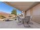 Inviting covered patio featuring a dining set overlooking the beautiful pool area at 7232 Frontier Hills Ave, Las Vegas, NV 89113