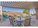 Charming patio area with a covered pergola and view of the pool and landscaped backyard at 7232 Frontier Hills Ave, Las Vegas, NV 89113