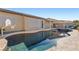Sparkling pool and patio area with mature landscaping and relaxing water feature at 7232 Frontier Hills Ave, Las Vegas, NV 89113