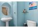 Charming powder room with a pedestal sink and vibrant blue walls, adding a splash of color at 7232 Frontier Hills Ave, Las Vegas, NV 89113