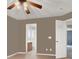 Bedroom with ceiling fan, light-colored walls, and ensuite bathroom at 7416 Tuckaway Harbor St, Las Vegas, NV 89139