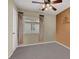 Bedroom with carpeted floors, ceiling fan, and exterior window with curtains at 7416 Tuckaway Harbor St, Las Vegas, NV 89139