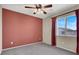 Bedroom featuring a ceiling fan, window, and plush carpeting at 7416 Tuckaway Harbor St, Las Vegas, NV 89139