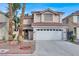 Lovely two-story home with a tile roof, attached two-car garage, and desert landscaping at 7416 Tuckaway Harbor St, Las Vegas, NV 89139