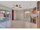 Spacious living area with tile floors, ceiling fan, and sliding glass doors to the pool at 7416 Tuckaway Harbor St, Las Vegas, NV 89139