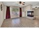 Spacious living room featuring a fireplace, neutral walls, and views of the outdoor space at 7416 Tuckaway Harbor St, Las Vegas, NV 89139