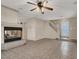 Open-concept living room with a fireplace, tile flooring, and a staircase at 7416 Tuckaway Harbor St, Las Vegas, NV 89139