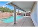 Inviting backyard pool with covered patio area and lush landscaping at 7416 Tuckaway Harbor St, Las Vegas, NV 89139
