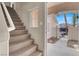 Carpeted staircase with natural light and views of the front yard at 7416 Tuckaway Harbor St, Las Vegas, NV 89139