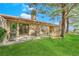 Cozy backyard with a covered patio, barbecue grill, and a comfortable seating area to enjoy the outdoor space at 7803 Canoe Ln, Las Vegas, NV 89145