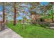 Relaxing backyard featuring a tranquil pond, mature trees, and a cozy bench for enjoying the scenery at 7803 Canoe Ln, Las Vegas, NV 89145