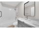 Bright bathroom featuring a shower-tub combination and a modern vanity with a marble countertop at 7803 Canoe Ln, Las Vegas, NV 89145