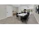 Open-concept dining area with marble table, modern decor, tile flooring, and access to the living room at 7803 Canoe Ln, Las Vegas, NV 89145
