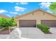 Charming single-story home with a two-car garage, manicured landscaping, and a welcoming facade at 7803 Canoe Ln, Las Vegas, NV 89145